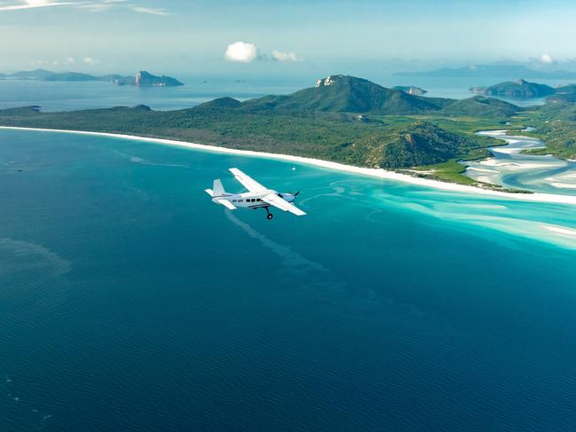 Five people have been transferred to Hamilton Island after a sea plane crashed into waters off Whitehaven Beach, Whitsunday Island.