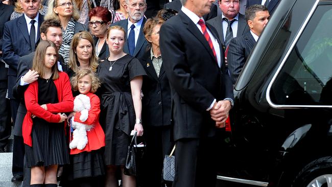 The wife and children (left) of Ken Talbot stand outside St Johns cathedral, as the mining magnate is taken away following his funeral in Brisbane, Wednesday, July 14, 2010. Mr Talbot was travelling with a team of Sundance executives when their chartered plane crashed in thick jungle in west Africa last month. (AAP Image/Dave Hunt) NO ARCHIVING