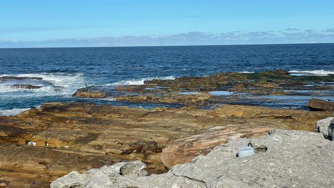 The rock platform where the pair were swept away