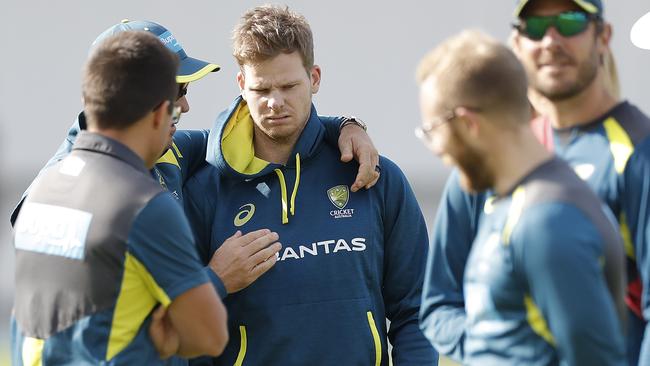 Justin Langer comforts Steve Smith after informing him of the news.