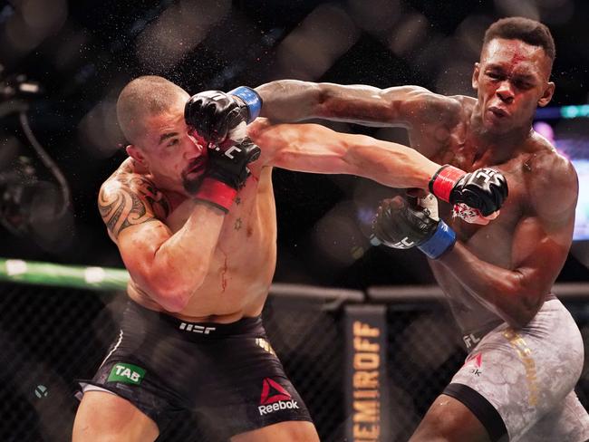 Robert Whittaker of Australia is hit by Israel Adesanya.