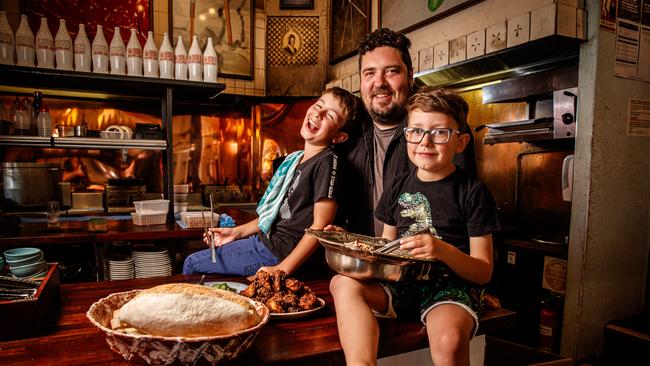 Duncan Welgemoed cooks with his sons Max, 9, and Alex, 6, his Africola restaurant. Picture Matt Turner