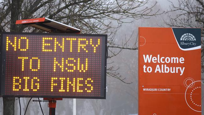 A sign is displayed regarding COVID-19 restrictions in the NSW, Victoria border town of Albury. Picture: David Gray/Getty Images