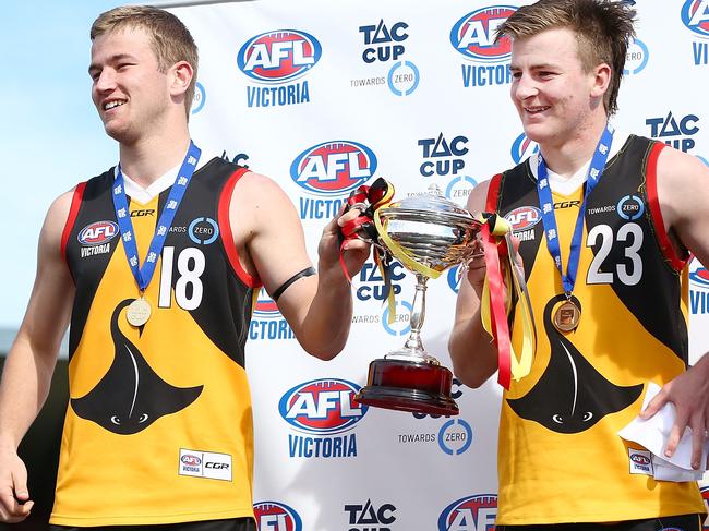 Stingrays co-captains Mitch Riordan (left) and Campbell Hustwaite raise the 2018 premiership cup.