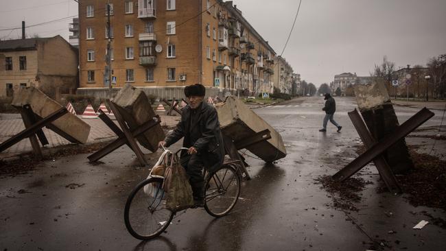 A resident rides his bike through street barricades in Bakhmut, Ukraine, as Russia continues its campaign to seize the city. Picture: Getty Images