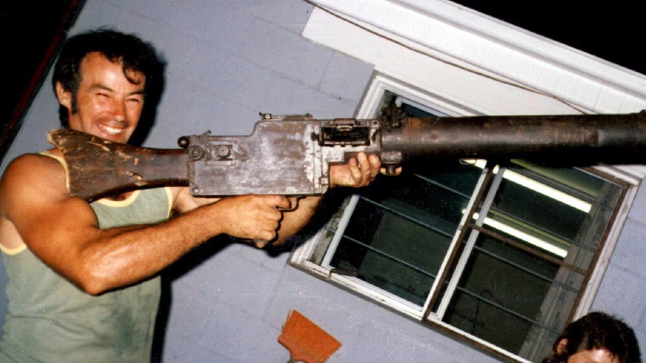 Milat in 1983 holding a WWI machine gun at his brother’s Buxton home.