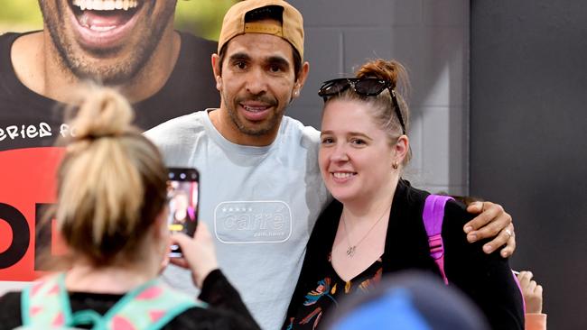 Eddie Betts poses for photos with fans during his book signing in Adelaide on Friday. Pic: AAP