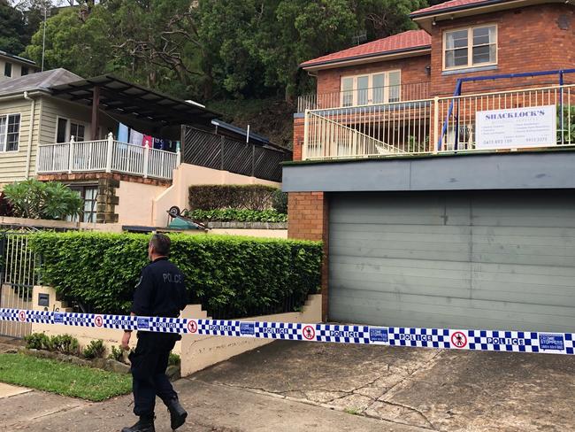 Police have cordoned off, and are guarding, several homes in Garden St, North Narrabeen and not allowing occupants back due to concerns that rain-sodden land behind the house could slip down a steep slope and damage houses. Picture: Jim O'Rourke