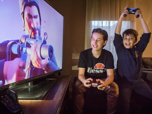 Leroy, 14, and Otis, 9, love playing Fortnite, and shouldn’t be banned from doing so, according to parenting expert Justin Coulson. Picture: Jason Edwards