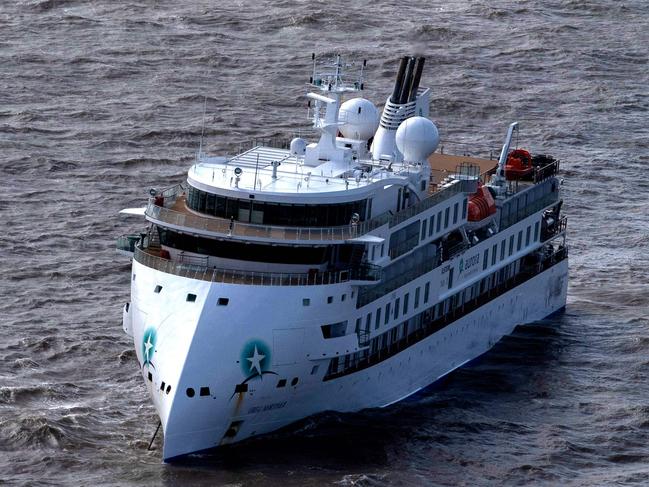 Aerial view of Australian cruise ship Greg Mortimer off the port of Montevideo on April 7, 2020. - Australian and New Zealand passengers on board a cruise ship off the South American coast will be the first flown home in a series of rescue flights as coronavirus on the ship rose sharply Tuesday, according to the Greg Mortimer's operator. Confirmed COVID-19 cases on the ship -  currently anchored in the Rio de la Plata near Uruguay - jumped from 81 to 128 on Tuesday with a medical flight for the Australians onboard expected to begin Thursday. (Photo by Pablo PORCIUNCULA / AFP)