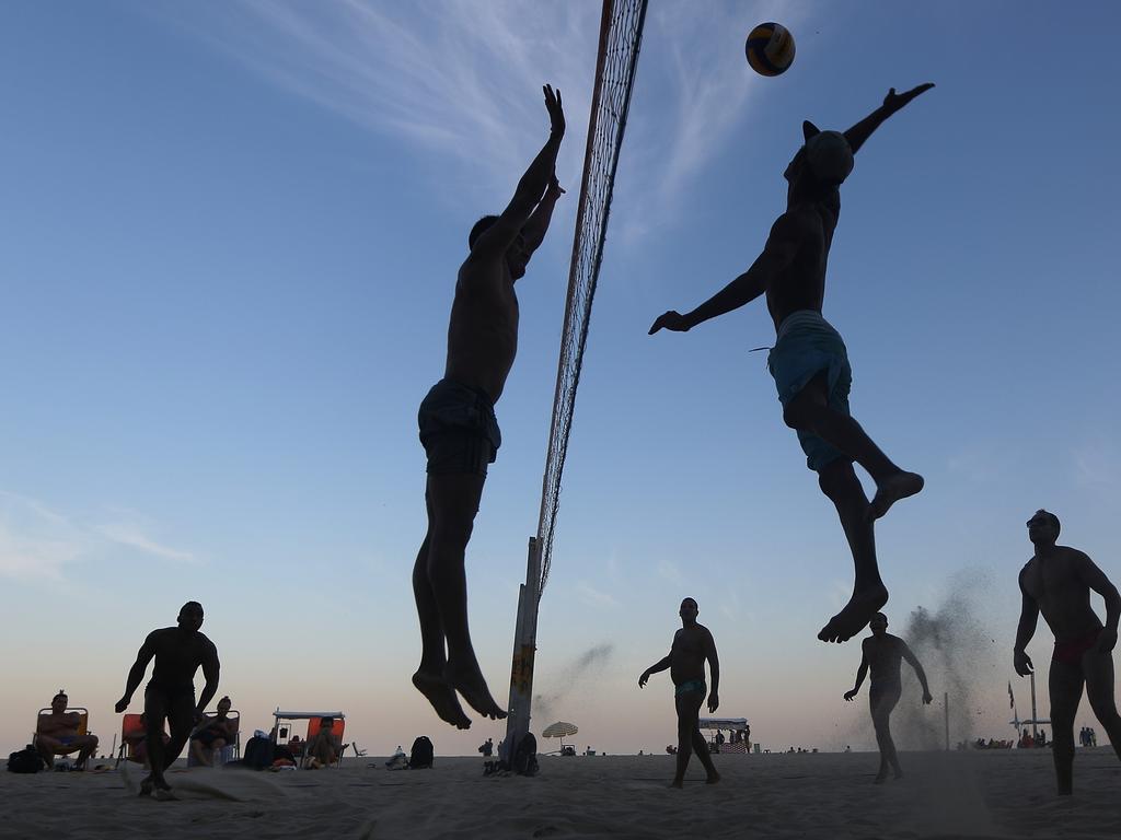 Brazilians play beach volleyball on Copacabana beach, near the Rio 2016 Olympic Games beach volleyball stadium, on July 24, 2016 in Rio de Janeiro, Brazil. Beach volleyball has been an official Olympic sport since 1996 and Brazil has won a gold or silver medal in every women’s and men’s competition since 1996. The U.S. and Brazil have traditionally had the two best teams in the sport. Picture: Mario Tama/Getty Images