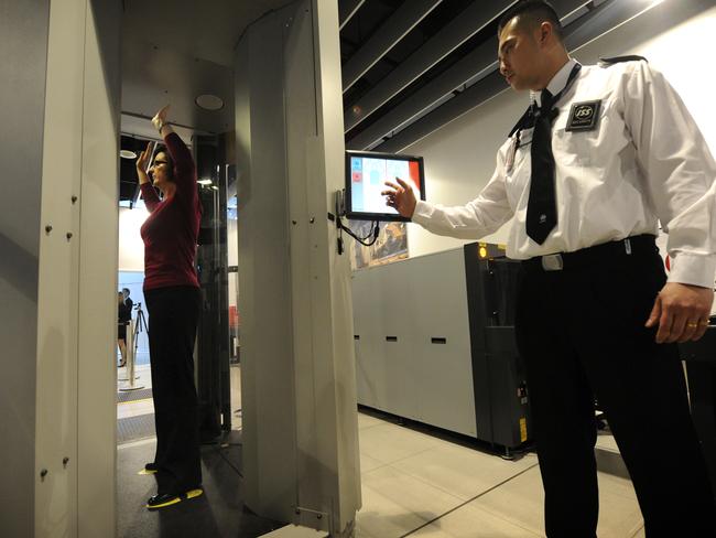 A woman undergoes a full body scan at Melbourne International Airport, a security measure that may be introduced for domestic flights. .