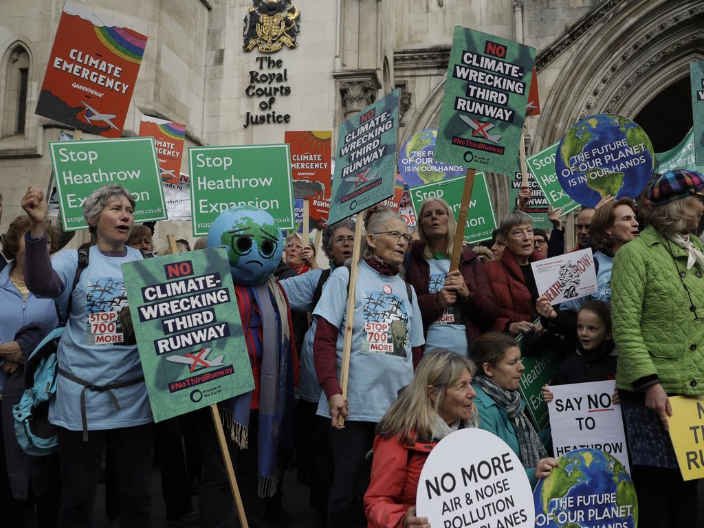 Campaigners against a third runway at Britain’s Heathrow outside the Supreme Court. Picture: AP Photo/Matt Dunham