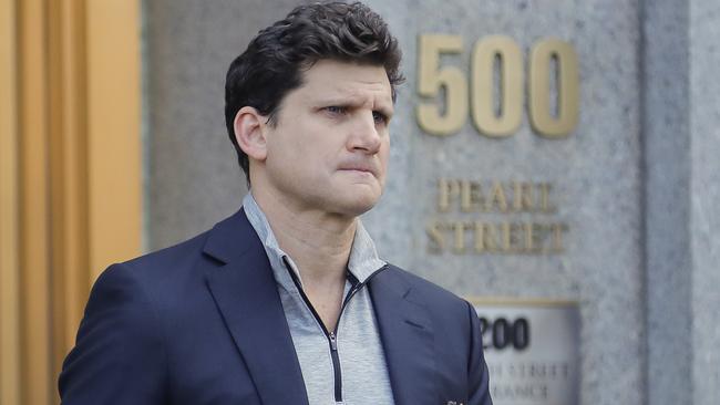 Gordon Caplan walks out of a New York court after being charged over the bribery scheme. Pic: AP