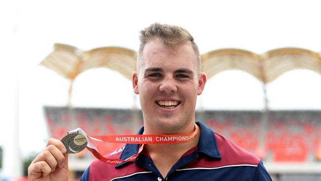 Matthew Denny celebrates after winning the men's hammer throw.