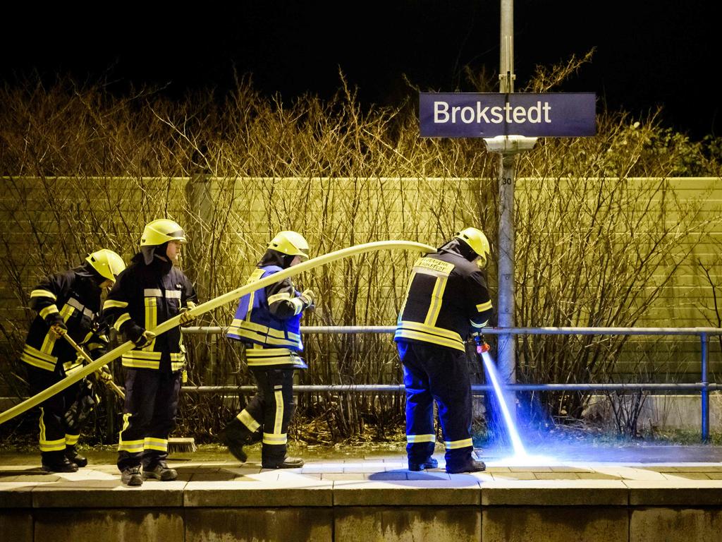 Firefighters clean the platform at the train station in Brokstedt after two people were killed and several others wounded in a knife attack on a regional train. Picture: Gregor Fischer / AFP