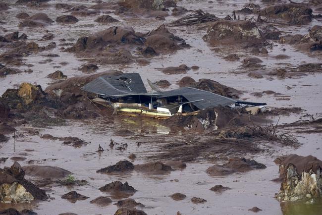 The dam collapse triggered a giant mudslide that swamped villages, rivers and rainforest, killing 19 people