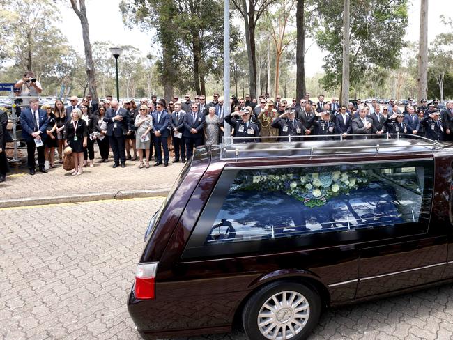 A hearse passes at the memorial service with full police honours for constables Rachel McCrow and Matthew Arnold at Brisbane Entertainment Centre. Picture: Steve Pohlner