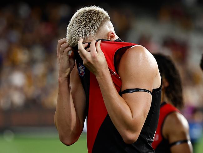 MELBOURNE, AUSTRALIA - MARCH 14: Nate Caddy of the Bombers looks dejected after a loss during the 2025 AFL Round 01 match between the Hawthorn Hawks and the Essendon Bombers at the Melbourne Cricket Ground on March 14, 2025 in Melbourne, Australia. (Photo by Michael Willson/AFL Photos via Getty Images)