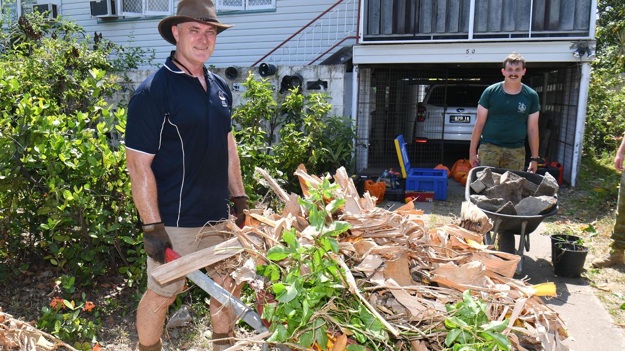 Townsville RSL Treasurer Scott Klima and Private Tom Groves from 3RAR help to clear up Emma Aldridge's backyard. Picture: Evan Morgan