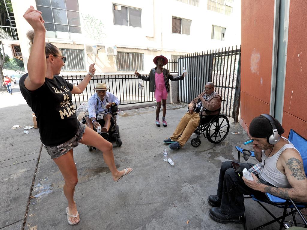 Shayne Evans dances with those she helps each month in Skid Row. Picture: Jeff Rayner (Coleman-Rayner)