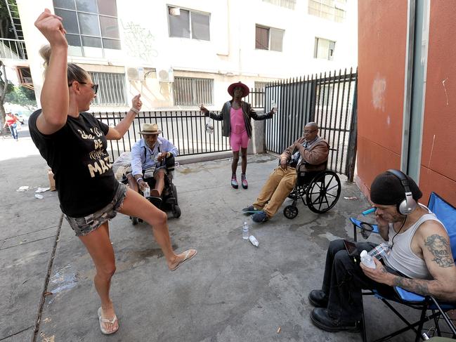 Shayne Evans dances with those she helps each month in Skid Row. Picture: Jeff Rayner (Coleman-Rayner)