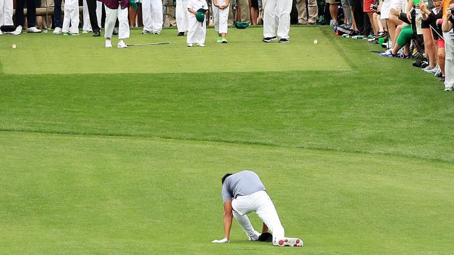Tony Finau of the United States falls after rolling his ankle while celebrating his hole-in-one on the seventh hole.
