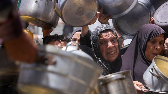 Displaced Palestinians plead for food aid at a charity station in Jabalia, in the northern Gaza Strip. Picture: AFP