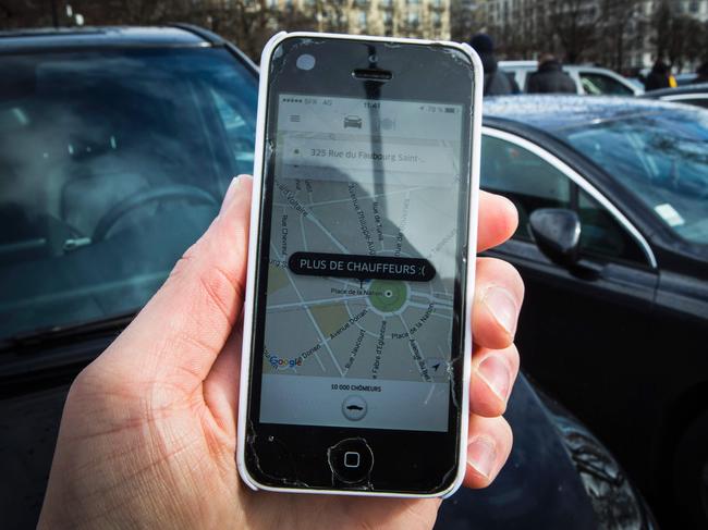 (FILES) This file photo taken on February 9, 2016 in Paris shows a smartphone displaying the app for ride service Uber with a box reading "No more drivers", as Uber suspends the app from 11am to 3pm in support of protesting non-licensed private hire cab drivers.  Uber drivers in France express grievances against the US-based transport company Uber, such as degraded working conditions, low financial viability and the increasing risk of accidents. In an attempt to regulate the sector, a bill, already passed by the Parliament, will be examined in the French Senate on November 2, 2016. / AFP PHOTO / Geoffroy Van der Hasselt