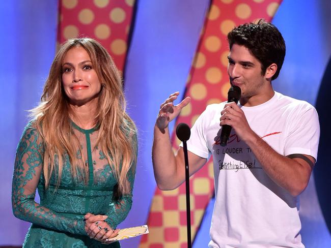 Jennifer Lopez and actor Tyler Posey onstage during FOX’s 2014 Teen Choice Awards. Picture: Getty