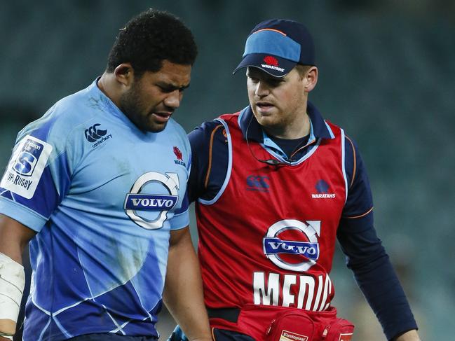 Tatafu Polota-Nau is helped from the field while playing for the Waratahs. The hooker has suffered seven major concussions.Picture: Mitch Cameron