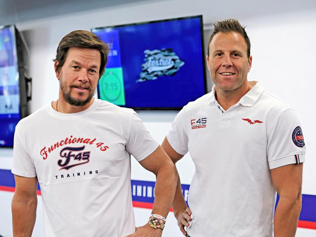 F45 co-founder Rob Deutsch, right, with actor Mark Wahlberg, who bought a minority stake in the company in 2019. Picture: Instagram / F45 Training