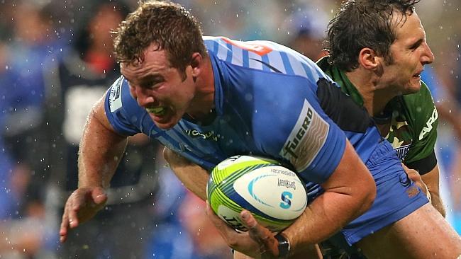 Angus Cottrell looks to break a tackle by Jurgen Visser in the Force’s match against the Bulls.