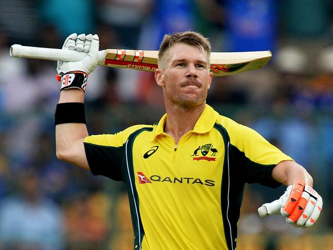 Australian cricketer David Warner (L) raises his bat to celebrate his century (100 runs) while his partner Aaron Finch looks on during the fourth one day international (ODI) match in the ongoing India-Australia cricket series at the M. Chinnaswamy Stadium in Bangalore on September 28, 2017. / AFP PHOTO / Manjunath KIRAN / ----IMAGE RESTRICTED TO EDITORIAL USE - STRICTLY NO COMMERCIAL USE----- / GETTYOUT