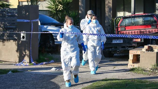 Crime scene cleaners outside the house of a murder scene in Epping. Picture: Ian Currie