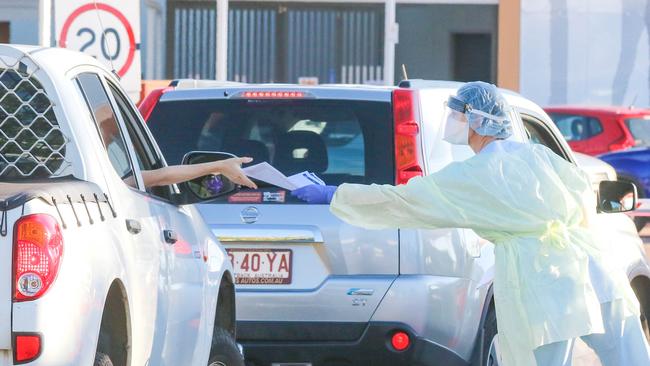 {People queue for testing in the Top End as new contact sites are named. Picture: Glenn Campbell