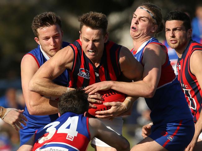 Ryan Mullett is sandwiched by St Paul's opponents during last year’s Southern Division 1 grand final. Picture: Hamish Blair