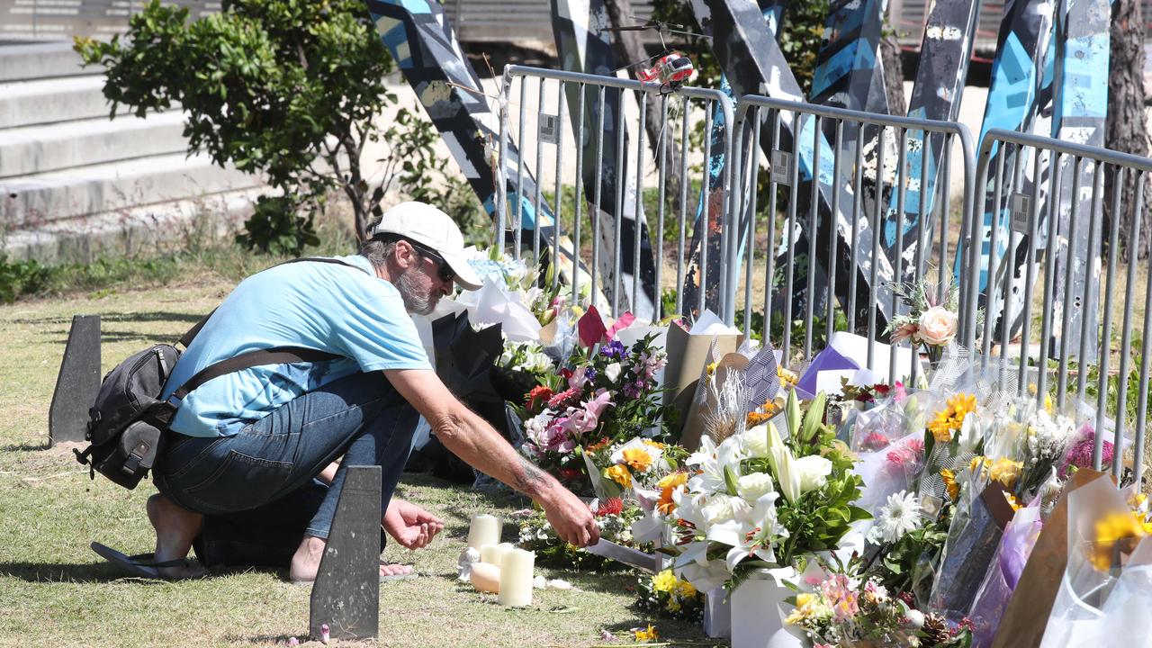 People view and drop off flowers at the helicopter crash memorial site at Broadwater Parklands. Picture Glenn Hampson