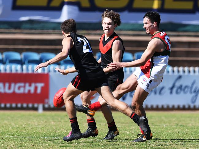 Izak Rankine of Henley kicks past Scott Kaya of Rostrevor during Rostrevor v Henley state knockout footy preliminary final at Woodville Oval Tuesday August 14,208. (Image AAP/Mark Brake)