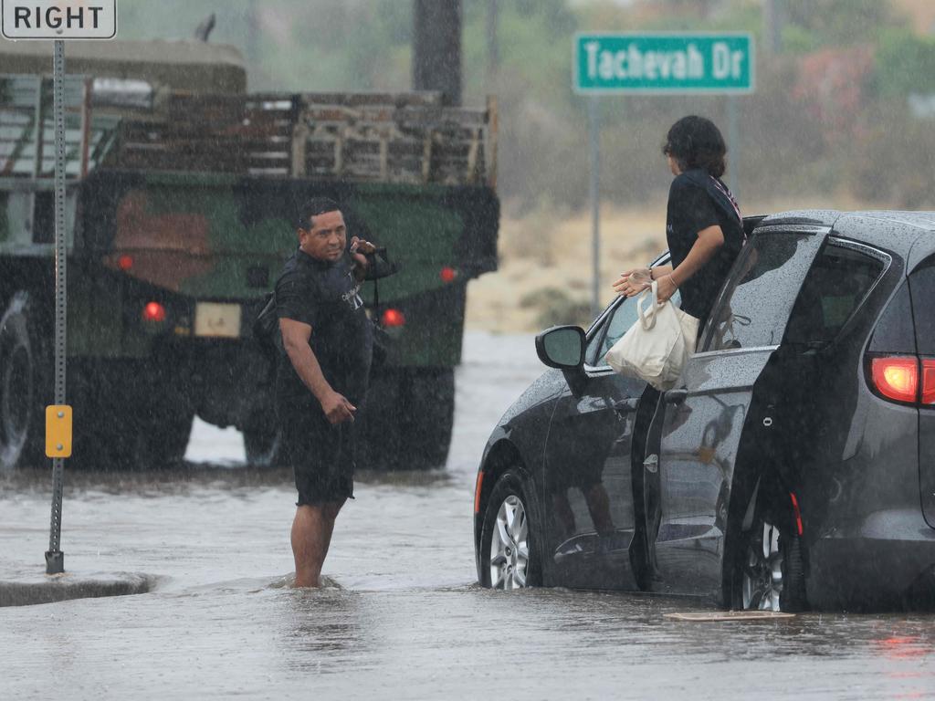 Motorists leave their vehicle stuck on a flooded road during heavy rains in Palm Springs, California. Picture: AFP