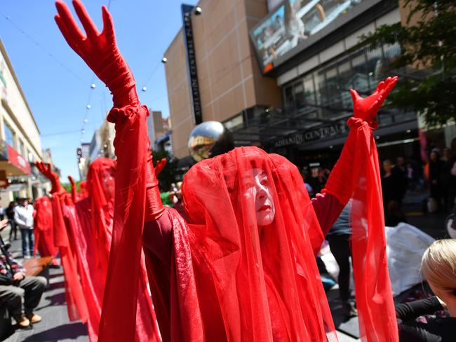 Activists from Extinction Rebellion participate in a protest in Adelaide, Wednesday, October 9, 2019. The Extinction Rebellion climate protests movement has planned a "spring rebellion" from Monday to Sunday, including marches aimed at blocking traffic. (AAP Image/David Mariuz) NO ARCHIVING