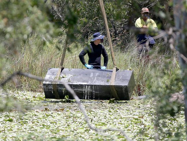 Toolbox murder -  Police retrieve a metal box from a dam near Srubby Creek in Kingston, double murder Logan. Pic Jono Searle.