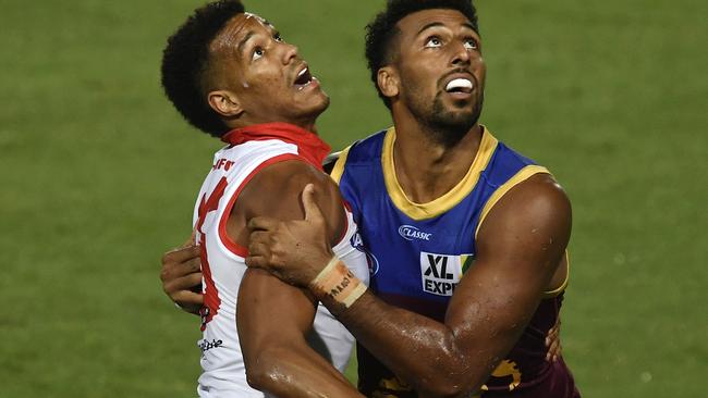 CAIRNS, AUSTRALIA - SEPTEMBER 13: Joel Amartey of the Swans and Archie Smith of the Lions compete for the ball during the round 17 AFL match between the Sydney Swans and the Brisbane Lions at Cazaly's Stadium on September 13, 2020 in Cairns, Australia. (Photo by Ian Hitchcock/Getty Images)