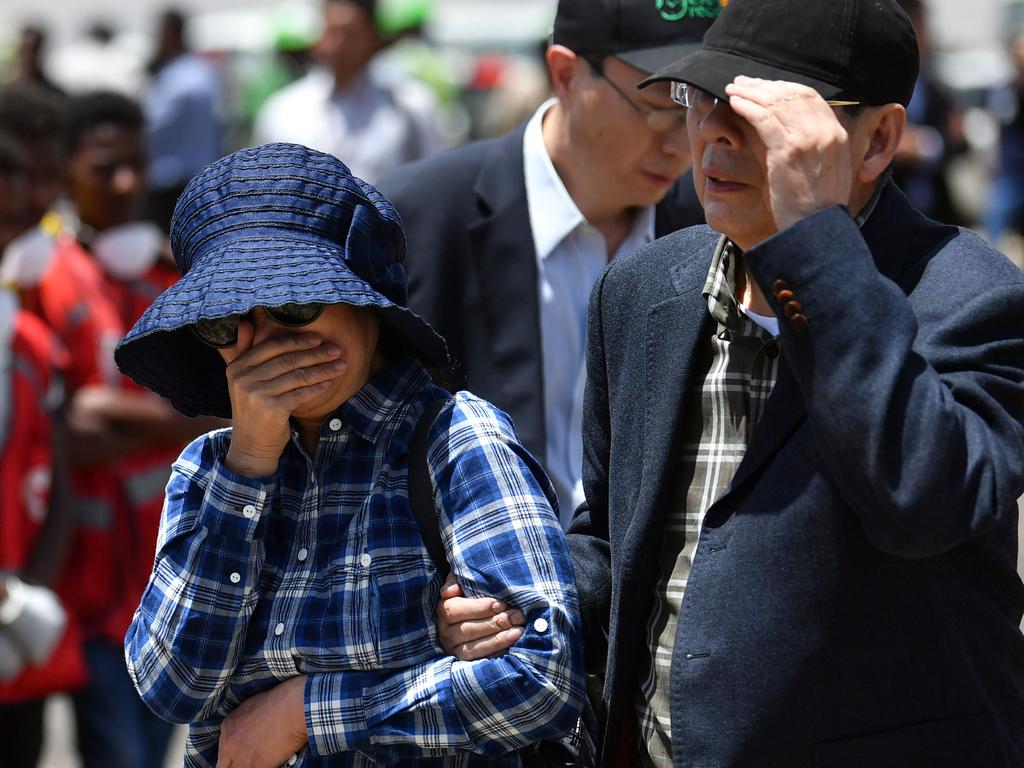 Relatives of the victims of the plane crash weep as they visit the crash site. Picture: AFP