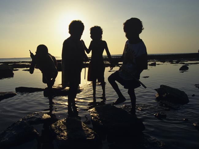 Aboriginal children play among the rocks at low tide on north coast of Arnhem Land (Photo by Ben Tweedie/Corbis via Getty Images)