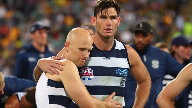 Devastated Cats Tom Hawkins and Gary Ablett after the final siren.