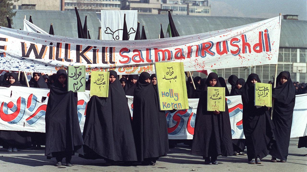 Iranian women are seen holding banners which read ‘Kill Salman Rushdie’ during a demonstration against the British writer in 1989. Picture: Norbert Schiller/AFP