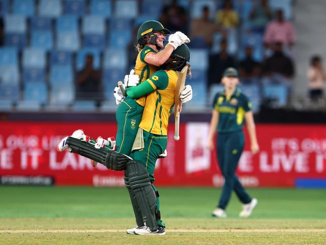 DUBAI, UNITED ARAB EMIRATES - OCTOBER 17: Anneke Bosch of South Africa celebrates victory with teammate Chloe Tryon after defeating Australia during the ICC Women's T20 World Cup Semi-Final between Australia and South Africa at Dubai International Stadium on October 17, 2024 in Dubai, United Arab Emirates. (Photo by Francois Nel/Getty Images)