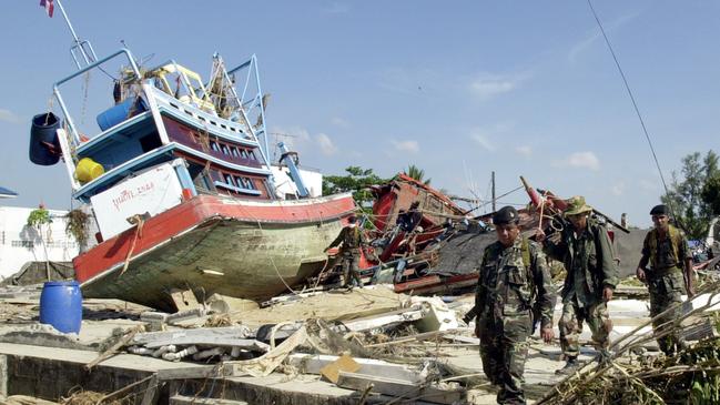 December 28, 2004: Thai soldiers survey the damage caused by a massive tsunami that struck the country a few days earlier. Photo: AP Photo/Apichart Weerawong.