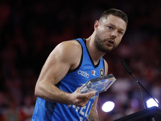 WOLLONGONG, AUSTRALIA - MARCH 23: Matthew Dellavedova of Melbourne United hands over his Finals MVP award to William Hickey of the Hawks during game five of the NBL Grand Final Series between Illawarra Hawks and Melbourne United at WIN Entertainment Centre, on March 23, 2025, in Wollongong, Australia. (Photo by Darrian Traynor/Getty Images)